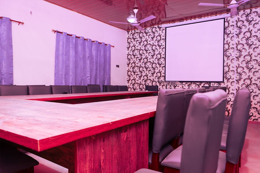 The conference hall, with projector screen and boardroom table