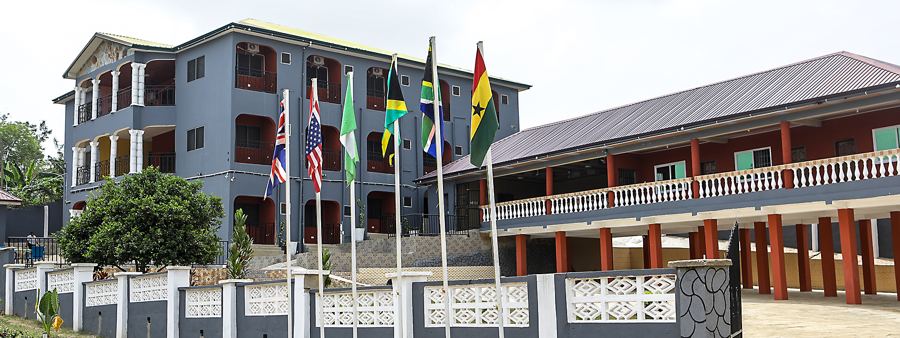 The main building and guest wing, with flags at the entrance