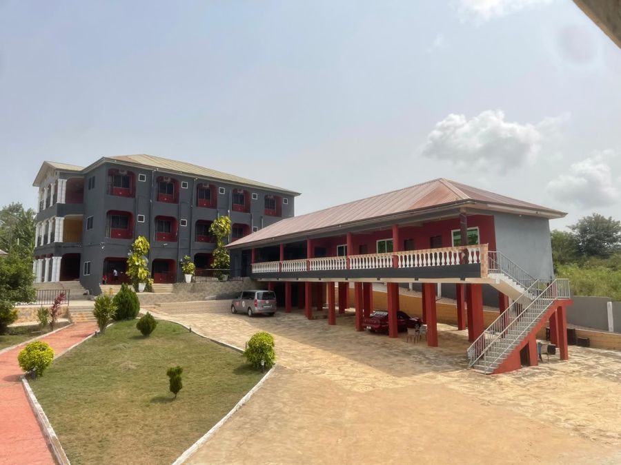 The main building and guest wing, with parking under the wing